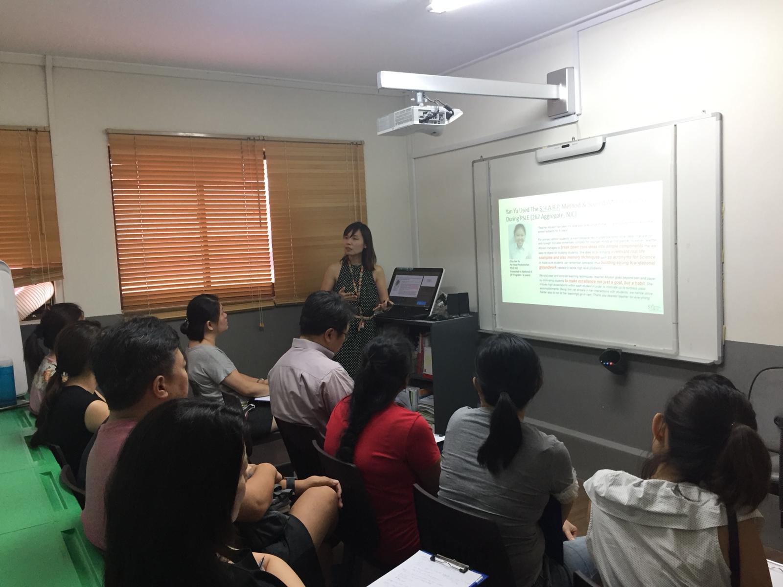 Teacher talking about PSLE approach on digital board at Stepping Stones Learning Centre