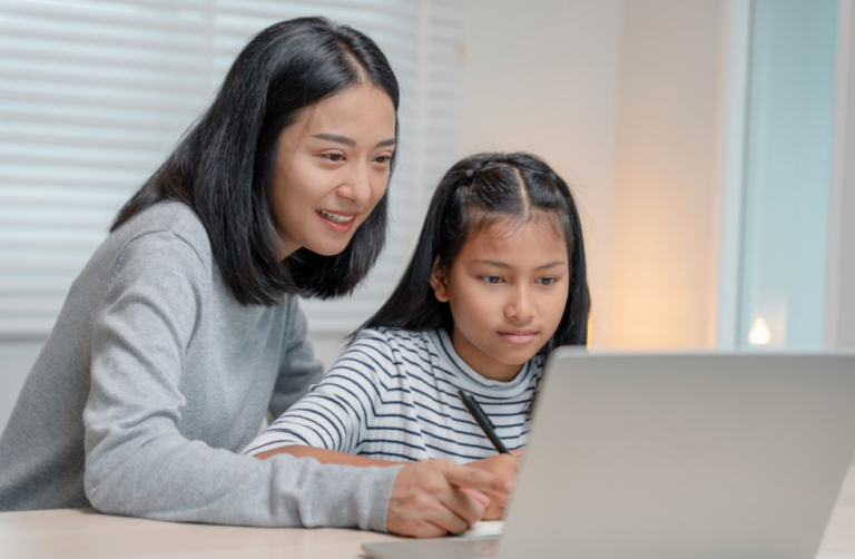 A mother helping her daughter with schoolwork.