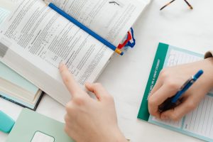 A student focused on studying Maths from a textbook