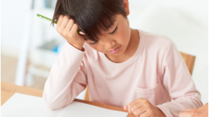 A child struggling while studying