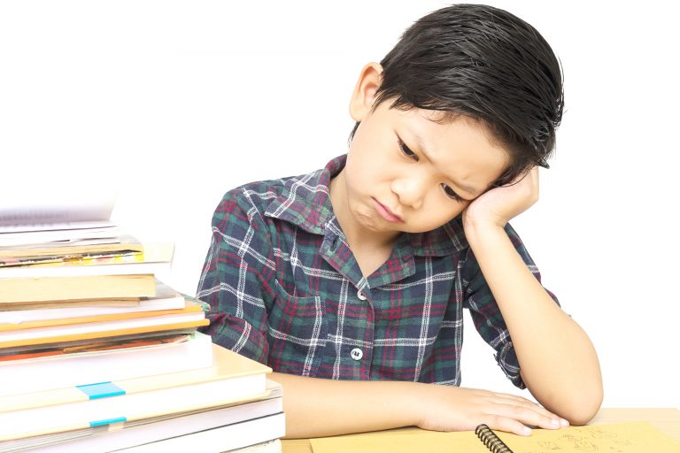 Young boy struggling with studies