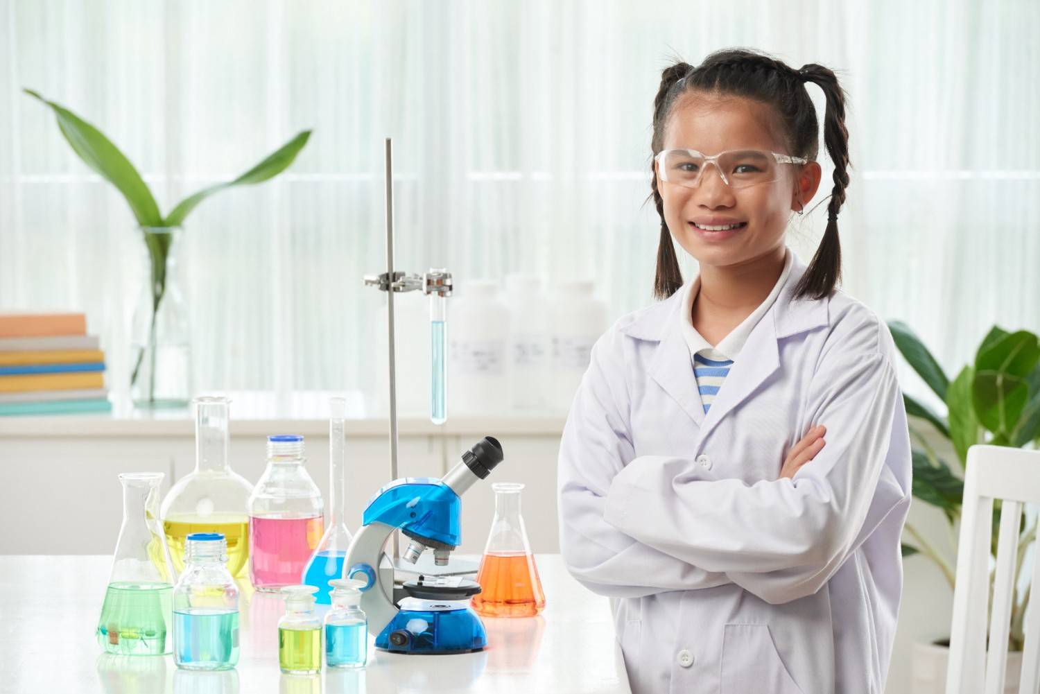 Happy young student in school laboratory