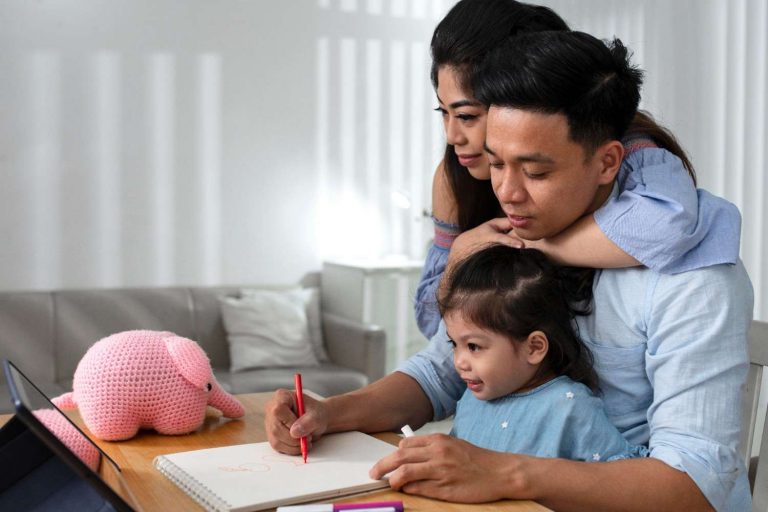 Parents teaching their daughter at home
