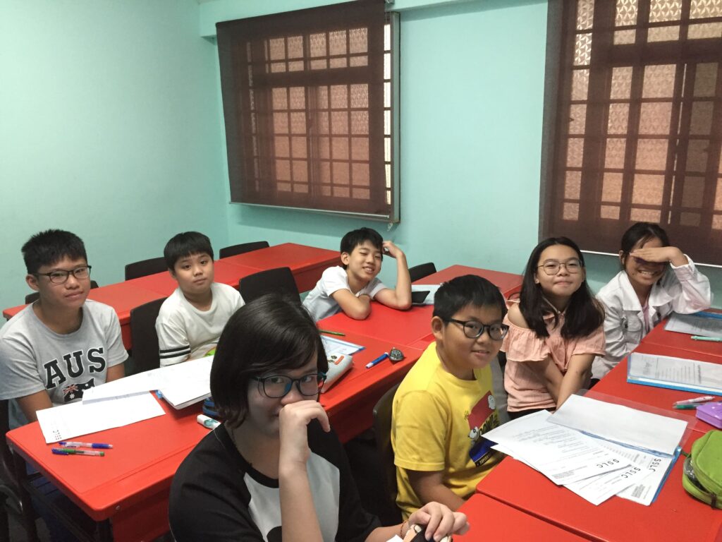 Students in class at Stepping Stones Learning Centre with worksheets on desks
