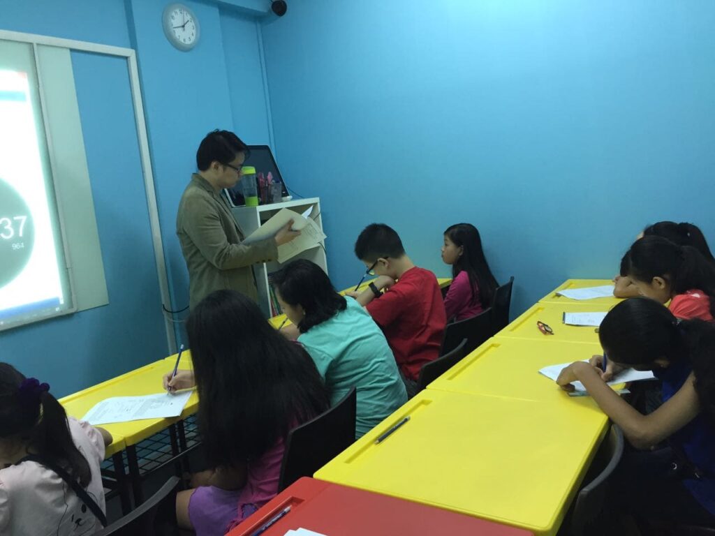 Teacher Adam guiding students at Stepping Stones Learning Centre during a lesson