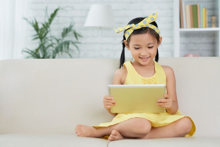 Child reading an e-book on a tablet at home