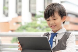 Young boy using a tablet for online learning