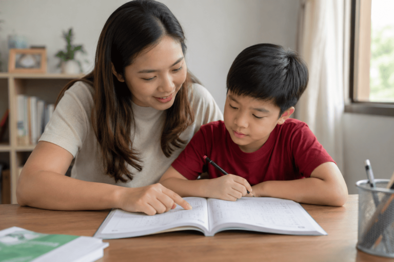 Parent helping son with maths homework at home