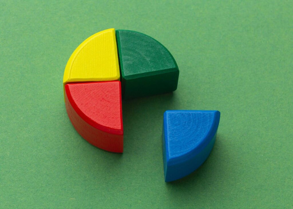 Colorful wooden fraction pie pieces used to teach quarters and fractions